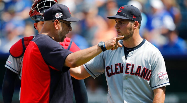 FILE - In a Sunday, July 28, 2019 file photo, Cleveland Indians manager Terry Francona, left, has words with pitcherTrevor Bauer, right, as Bauer is taken out in the fifth inning of a baseball game against the Kansas City Royals at Kauffman Stadium in Kan