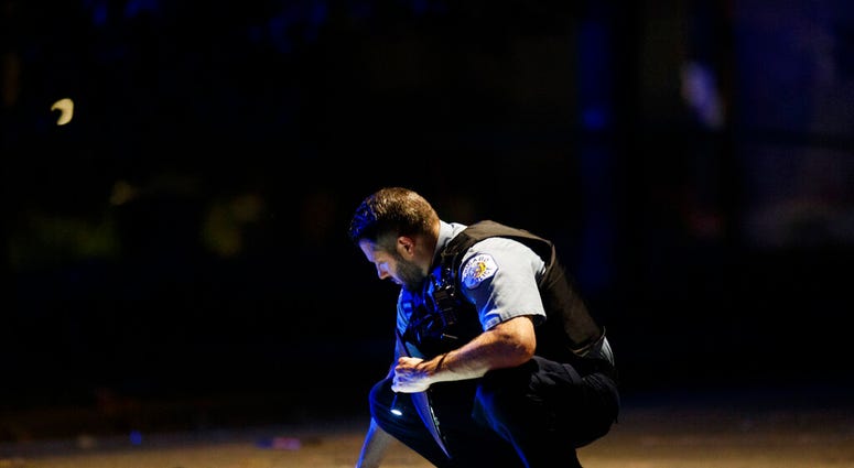 An officer investigates the scene of a shooting in Chicago on Sunday, July 5, 2020. (Armando L. Sanchez/Chicago Tribune via AP) An officer investigates the scene of a shooting in Chicago on Sunday, July 5, 2020. (Armando L. Sanchez/Chicago Tribune via AP)