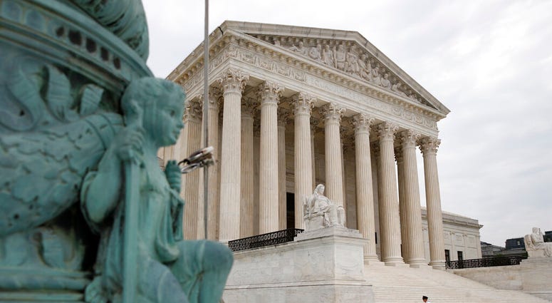 A police officer walks outside the Supreme Court on Capitol Hill in Washington, Monday, July 6, 2020. (AP Photo/Patrick Semansky) A police officer walks outside the Supreme Court on Capitol Hill in Washington, Monday, July 6, 2020. (AP Photo/Patrick Semansky)