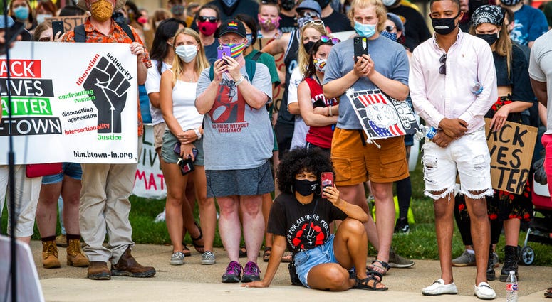 Demonstrators listen to Amrita Chakrabarti Myers speak at the Monroe County courthouse, Monday, July 6, 2020, in Bloomington, Ind., in response to the attack on Vauhxx Booker.