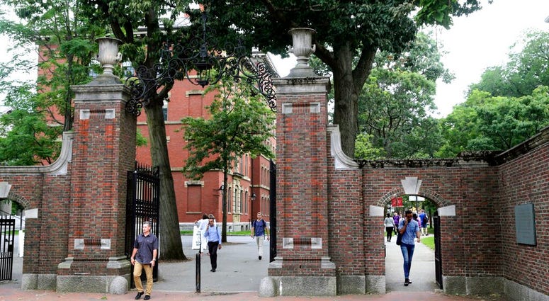 FILE - In this Aug. 13, 2019, file photo, pedestrians walk through the gates of Harvard Yard at Harvard University in Cambridge, Mass. (AP Photo/Charles Krupa, File) FILE - In this Aug. 13, 2019, file photo, pedestrians walk through the gates of Harvard Yard at Harvard University in Cambridge, Mass. (AP Photo/Charles Krupa, File)