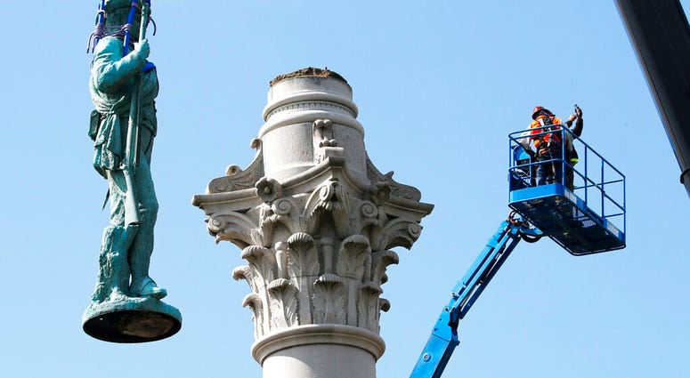 Crews remove the Confederate Soldiers & Sailors Monument in Libby Hill Park, Wednesday, July 8, 2020, in Richmond, Va.