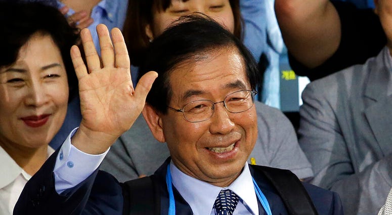 FILE - In this June 5, 2014, file photo, Park Won-soon, then candidate for Seoul city mayor of the main opposition party New Politics Alliance for Democracy celebrates his victory in the Seoul mayoral election at his office in Seoul, South Korea.