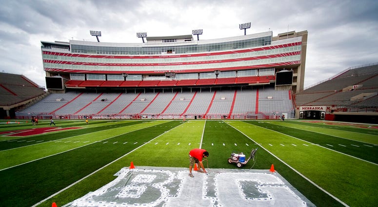 FILE - In this Thursday, Oct. 6, 2011 file photo, Turf manager Jared Hertzel touches up the newly-painted Big Ten conference logo on the football field at Memorial Stadium in Lincoln, Neb.