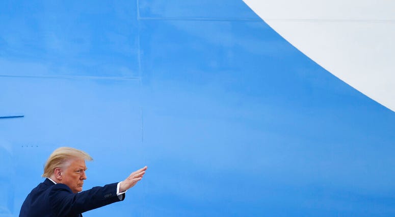 President Donald Trump waves from the top of the steps of Air Force One at Andrews Air Force Base in Md., Friday, July 10, 2020.