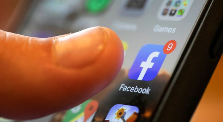 FILE - In this Aug. 11, 2019, file photo, an iPhone displays the Facebook app in New Orleans.