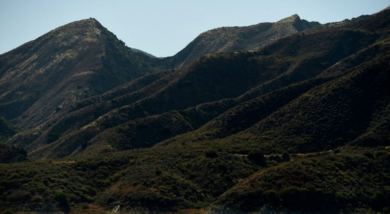 A search-and-rescue boat continues looking for missing actress Naya Rivera at Lake Piru, Friday, July 10, 2020, in Los Padres National Forest, Calif., about 55 miles (90 kilometers) northwest of Los Angeles.