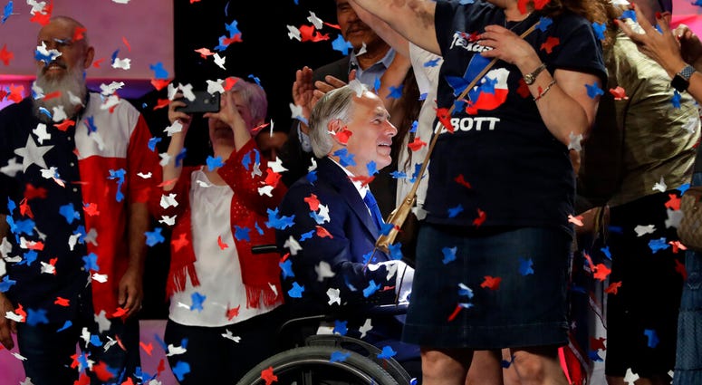File - In this June 15, 2018 file photo, Confetti falls as Texas Gov. Greg Abbott, center, greets supporters after speaking at the Texas GOP Convention, in San Antonio.