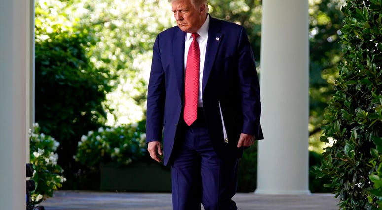 President Donald Trump arrives to speak at a news conference in the Rose Garden of the White House, Tuesday, July 14, 2020, in Washington.