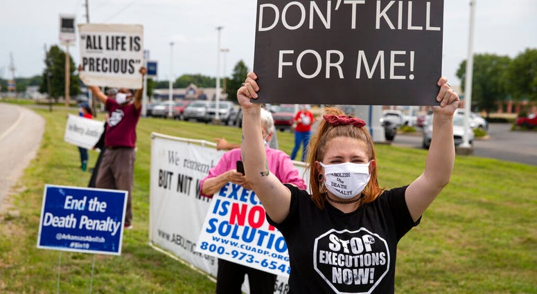 Protesters against the death penalty gather in Terre Haute, Ind., Wednesday, July 15, 2020. Wesley Ira Purkey, convicted of a gruesome 1998 kidnapping and killing, is scheduled to be executed Wednesday evening at the federal prison in Terre Haute.