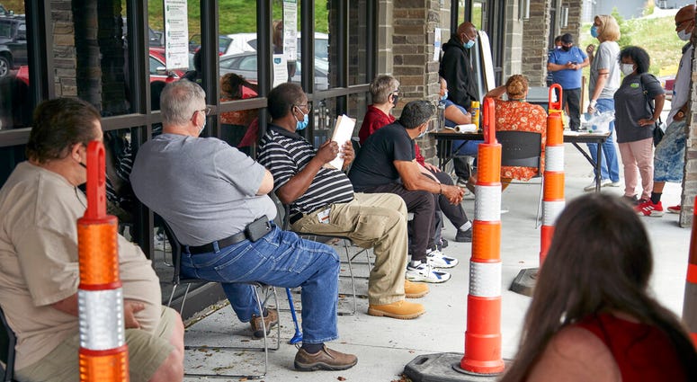 Job seekers exercise social distancing as they wait to be called into the Heartland Workforce Solutions office in Omaha, Neb., Wednesday, July 15, 2020.