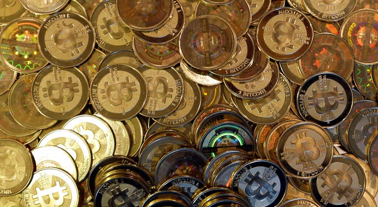 FILE - This April 3, 2013, file photo shows bitcoin tokens in Sandy, Utah.