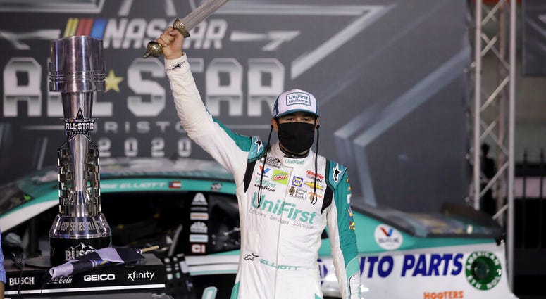Chase Elliott celebrates with the trophy after winning a NASCAR All-Star auto race at Bristol Motor Speedway in Bristol, Tenn, Wednesday, July 15, 2020.