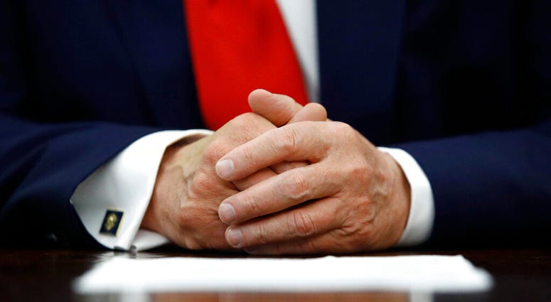 FILE - In this July 15, 2020, file photo President Donald Trump participates in a law enforcement briefing on the MS-13 gang in the Oval Office of the White House in Washington.
