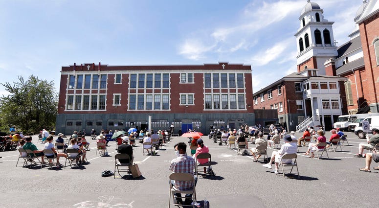 Church parishioners sit apart at a prayer vigil for racial justice at Immaculate Conception Catholic Church Sunday, July 19, 2020, in Seattle.