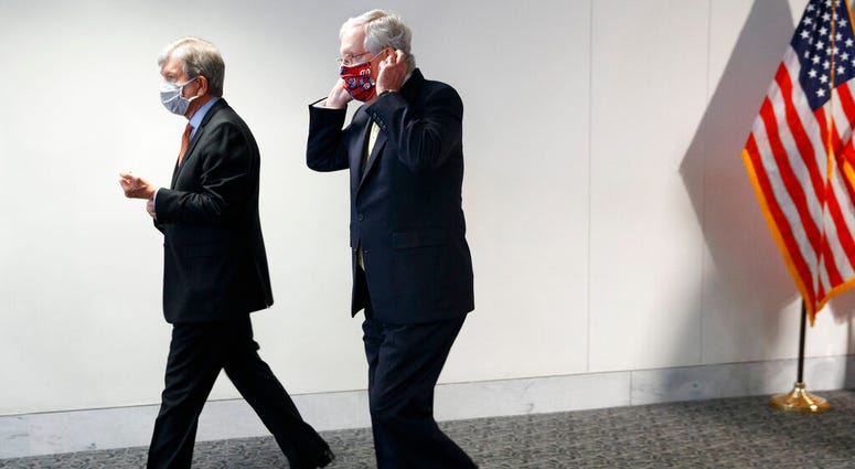 Sen. Roy Blunt, R-Mo., left, and Senate Majority Leader Mitch McConnell of Ky., leave a news conference after a Republican luncheon, Tuesday, July 21, 2020, on Capitol Hill in Washington.
