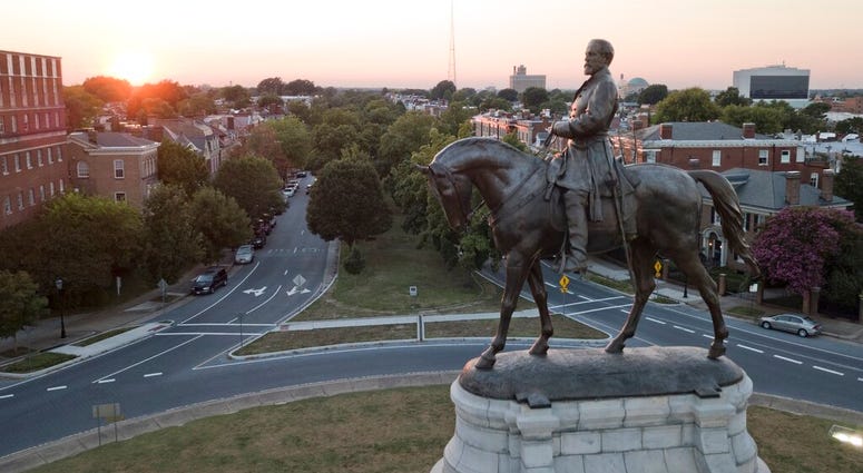 FILE - In this July 31, 2017 file photo, the sun sets behind the statue of confederate General Robert E. Lee on Monument Avenue in Richmond, Va. (AP Photo/Steve Helber) FILE - In this July 31, 2017 file photo, the sun sets behind the statue of confederate General Robert E. Lee on Monument Avenue in Richmond, Va. (AP Photo/Steve Helber)