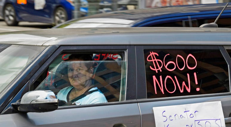 Motorists take part in a caravan protest in front of Senator John Kennedy's office at the Hale Boggs Federal Building asking for the extension of the $600 in unemployment benefits to people out of work because of the coronavirus in New Orleans, La. Wednes