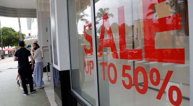 FILE - In this June 17, 2020 file photo, a sign advertises a sale at an H&M store along Lincoln Road Mall in Miami Beach, Fla.