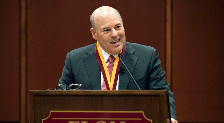 FILE - In this March 1, 2017, file photo, then Elon Trustee Louis DeJoy is honored with Elon's Medal for Entrepreneurial Leadership in Elon. N.C. U.S. Sen. Joe Manchin and union officials say the U.S. Postal Service is considering closing post offices acr