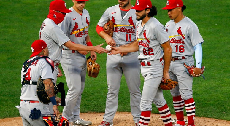 St. Louis Cardinals pitcher Daniel Ponce de Leon hands the ball over to manager Mike Shildt, left, after being pulled in the fifth inning of the team's baseball game against the Minnesota Twins on Wednesday, July 29, 2020, in Minneapolis. St. Louis Cardinals pitcher Daniel Ponce de Leon hands the ball over to manager Mike Shildt, left, after being pulled in the fifth inning of the team's baseball game against the Minnesota Twins on Wednesday, July 29, 2020, in Minneapolis.