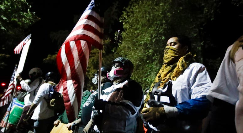 Military veterans participate in a Black Lives Matter protest at the Mark O. Hatfield United States Courthouse Thursday, July 30, 2020, in Portland, Ore.