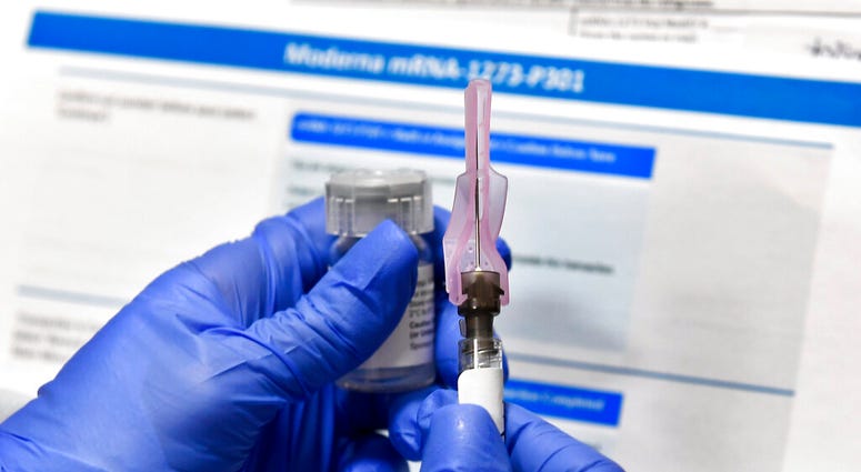 FILE - In this Monday, July 27, 2020 file photo, a nurse prepares a shot as a study of a possible COVID-19 vaccine, developed by the National Institutes of Health and Moderna Inc., gets underway in Binghamton, N.Y.