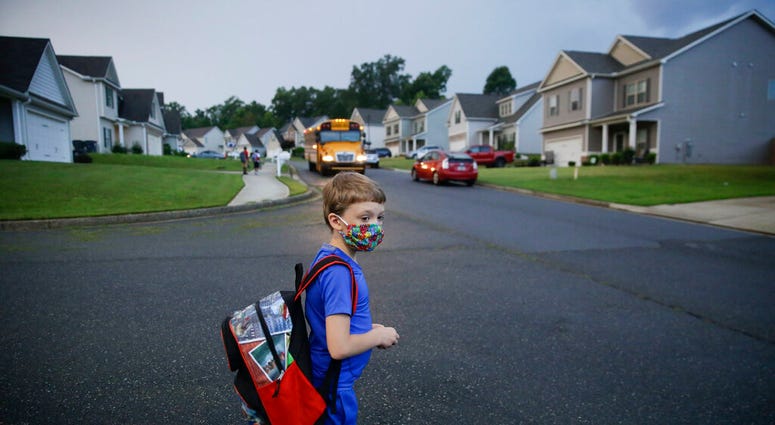 Paul Adams, 7, waits at the bus stop for the first day of school on Monday, Aug. 3, 2020, in Dallas, Ga. (AP Photo/Brynn Anderson) Paul Adams, 7, waits at the bus stop for the first day of school on Monday, Aug. 3, 2020, in Dallas, Ga. (AP Photo/Brynn Anderson)