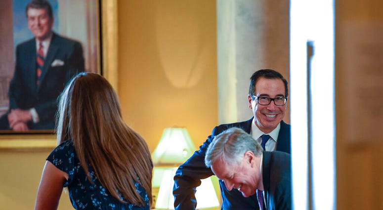 Treasury Secretary Steven Mnuchin, right, and White House Chief of Staff Mark Meadows, second from right, sit down in the office of Senate Majority Leader Mitch McConnell of Ky., on Capitol Hill in Washington, Monday, Aug. 3, 2020.