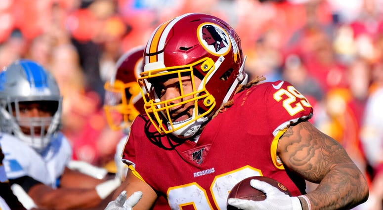 FILE - In this Nov. 24, 2019, file photo, Washington Redskins running back Derrius Guice (29) runs the ball during an NFL football game against the Detroit Lions in Landover, Md.