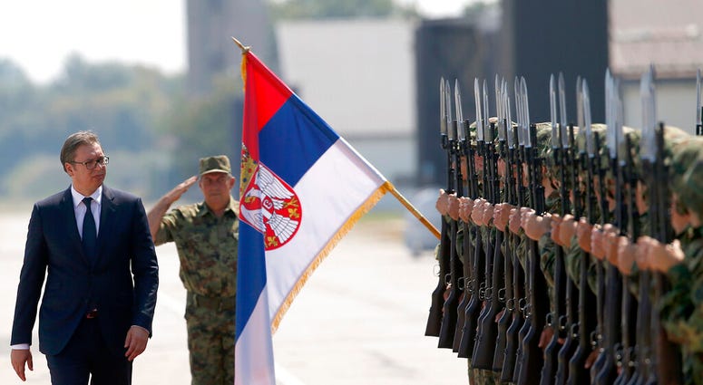 FILE - In this Tuesday, Aug. 21, 2018 file photo, Serbian President Aleksandar Vucic, left, reviews an honor guard on the tarmac at Batajnica, military airport near Belgrade, Serbia. (AP Photo/Darko Vojinovic) FILE - In this Tuesday, Aug. 21, 2018 file photo, Serbian President Aleksandar Vucic, left, reviews an honor guard on the tarmac at Batajnica, military airport near Belgrade, Serbia. (AP Photo/Darko Vojinovic)