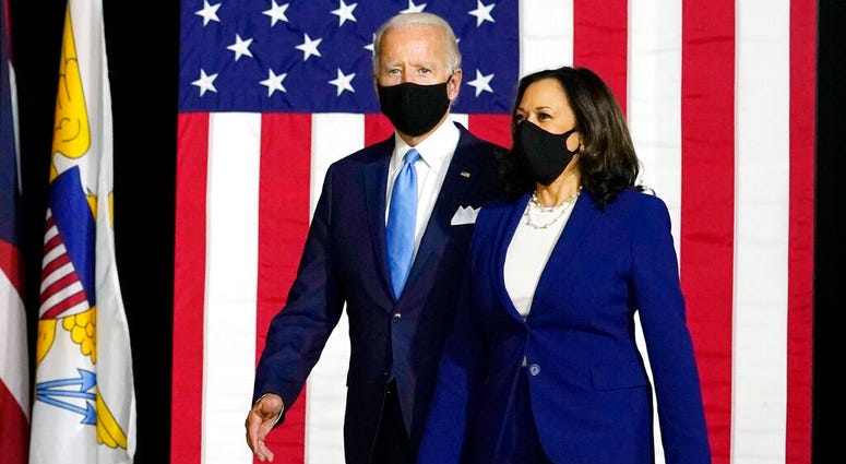 Democratic presidential candidate former Vice President Joe Biden and his running mate Sen. Kamala Harris, D-Calif., arrive to speak at a news conference at A.I.Dupont High School in Wilmington, Del., Wednesday, Aug. 12, 2020. (AP Photo/Carolyn Kaster) Democratic presidential candidate former Vice President Joe Biden and his running mate Sen. Kamala Harris, D-Calif., arrive to speak at a news conference at A.I.Dupont High School in Wilmington, Del., Wednesday, Aug. 12, 2020. (AP Photo/Carolyn Kaster)