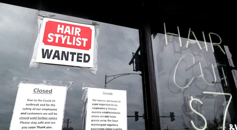 In this April 30 ,2020 file photo, a barber shop shows closed and hiring sign during the COVID-19 in Chicago. (AP Photo/Nam Y. Huh, File) In this April 30 ,2020 file photo, a barber shop shows closed and hiring sign during the COVID-19 in Chicago. (AP Photo/Nam Y. Huh, File)