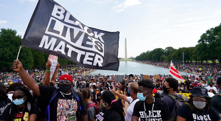 People attend the March on Washington, Friday Aug. 28, 2020, in Washington, on the 57th anniversary of the Rev. Martin Luther King Jr.'s "I Have A Dream" speech. (AP Photo/Carolyn Kaster) People attend the March on Washington, Friday Aug. 28, 2020, in Washington, on the 57th anniversary of the Rev. Martin Luther King Jr.'s "I Have A Dream" speech. (AP Photo/Carolyn Kaster)
