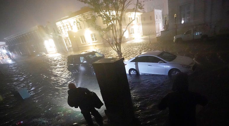 People use flashlights as they walk on flooded streets in search of their vehicle, Wednesday, Sept. 16, 2020, in Pensacola, Fla. (AP Photo/Gerald Herbert) People use flashlights as they walk on flooded streets in search of their vehicle, Wednesday, Sept. 16, 2020, in Pensacola, Fla. (AP Photo/Gerald Herbert)
