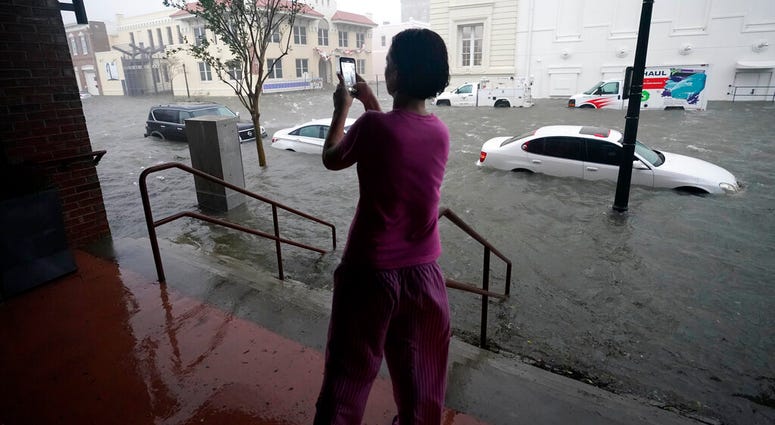 Flood waters move on the street, Wednesday, Sept. 16, 2020, in downtown Pensacola, Fla. Hurricane Sally made landfall Wednesday near Gulf Shores, Alabama. .(AP Photo/Gerald Herbert) Flood waters move on the street, Wednesday, Sept. 16, 2020, in downtown Pensacola, Fla. Hurricane Sally made landfall Wednesday near Gulf Shores, Alabama. .(AP Photo/Gerald Herbert)