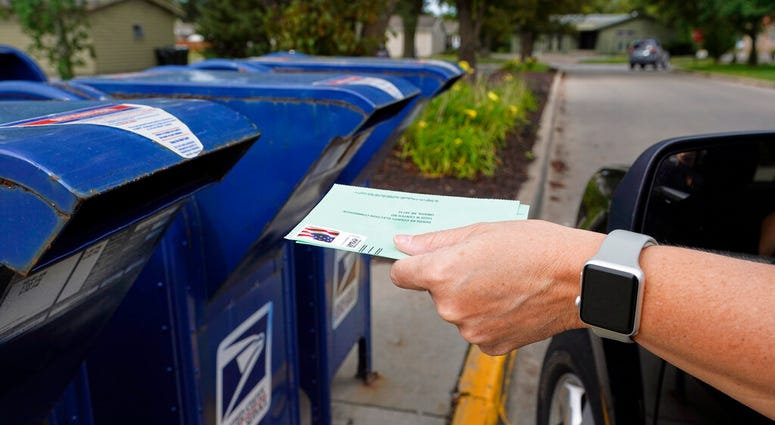 FILE - In this Tuesday, Aug. 18, 2020, file photo, a person drops applications for mail-in-ballots into a mailbox in Omaha, Neb. (AP Photo/Nati Harnik, File) FILE - In this Tuesday, Aug. 18, 2020, file photo, a person drops applications for mail-in-ballots into a mailbox in Omaha, Neb. (AP Photo/Nati Harnik, File)