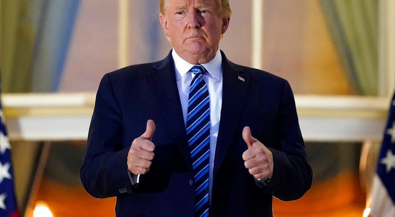 President Donald Trump stands on the balcony outside of the Blue Room as returns to the White House Monday, Oct. 5, 2020, in Washington, after leaving Walter Reed National Military Medical Center, in Bethesda, Md. (AP Photo/Alex Brandon) President Donald Trump stands on the balcony outside of the Blue Room as returns to the White House Monday, Oct. 5, 2020, in Washington, after leaving Walter Reed National Military Medical Center, in Bethesda, Md. (AP Photo/Alex Brandon)