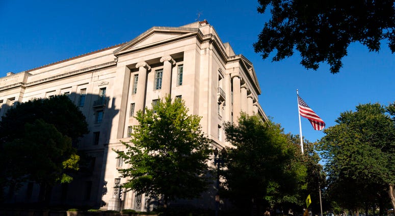 The American flag flies outside of the Justice Department building, Thursday, Oct. 8, 2020, in Washington. (AP Photo/Jacquelyn Martin) The American flag flies outside of the Justice Department building, Thursday, Oct. 8, 2020, in Washington. (AP Photo/Jacquelyn Martin)