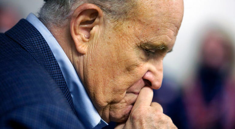 Former New York Mayor Rudy Giuliani pauses while addressing supporters of President Donald Trump supporters Monday, Oct. 12, 2020 during a Columbus Day gathering at a Trump campaign field office in Philadelphia. (AP Photo/Jacqueline Larma) Former New York Mayor Rudy Giuliani pauses while addressing supporters of President Donald Trump supporters Monday, Oct. 12, 2020 during a Columbus Day gathering at a Trump campaign field office in Philadelphia. (AP Photo/Jacqueline Larma)