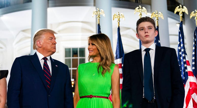 FILE - In this Aug. 27, 2020 file photo, Barron Trump right, stands with President Donald Trump and first lady Melania Trump on the South Lawn of the White House on the fourth day of the Republican National Convention in Washington. (AP Photo/Evan Vucci) FILE - In this Aug. 27, 2020 file photo, Barron Trump right, stands with President Donald Trump and first lady Melania Trump on the South Lawn of the White House on the fourth day of the Republican National Convention in Washington. (AP Photo/Evan Vucci)