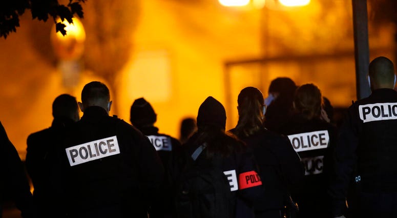 French police officers gather outside a high school after a history teacher who opened a discussion with students on caricatures of Islam's Prophet Muhammad was beheaded, Friday, Oct. 16, 2020 in Conflans-Saint-Honorine.(AP Photo/Michel Euler) French police officers gather outside a high school after a history teacher who opened a discussion with students on caricatures of Islam's Prophet Muhammad was beheaded, Friday, Oct. 16, 2020 in Conflans-Saint-Honorine.(AP Photo/Michel Euler)