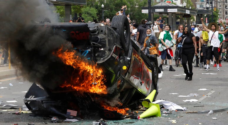 In this May 30, 2020, file photo, protesters demonstrate as a Salt Lake City police vehicle burns, in Salt Lake City. (AP Photo/Rick Bowmer, File) In this May 30, 2020, file photo, protesters demonstrate as a Salt Lake City police vehicle burns, in Salt Lake City. (AP Photo/Rick Bowmer, File)