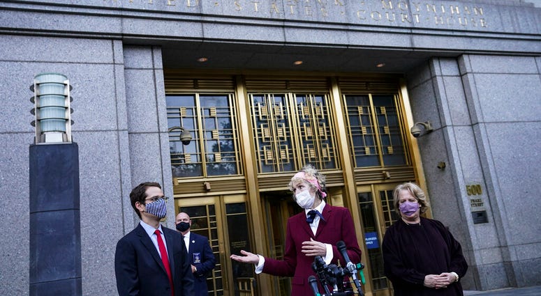 E. Jean Carroll, center, who says President Donald Trump raped her in the 1990s, speaks to reporters as she leaves the Daniel Patrick Moynihan United States Courthouse following a hearing in her defamation lawsuit against Trump, Wednesday, Oct. 21, 2020. E. Jean Carroll, center, who says President Donald Trump raped her in the 1990s, speaks to reporters as she leaves the Daniel Patrick Moynihan United States Courthouse following a hearing in her defamation lawsuit against Trump, Wednesday, Oct. 21, 2020.