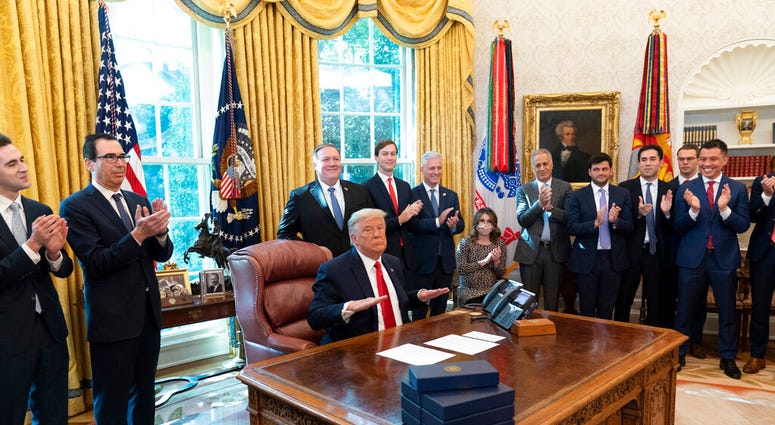 President Donald Trump reacts after hanging up a phone call with the leaders of Sudan and Israel. (AP Photo/Alex Brandon) President Donald Trump reacts after hanging up a phone call with the leaders of Sudan and Israel. (AP Photo/Alex Brandon)