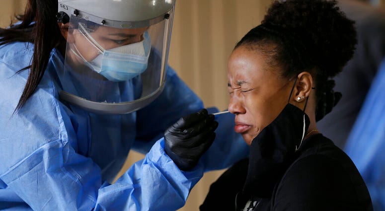 Sasha Jacquez tests The University of Texas at El Paso student Ariona Gill for coronavirus Friday, Oct. 16, 2020, at the UTEP Fox Fine Arts Center in El Paso, Texas. (Mark Lambie/The El Paso Times via AP) Sasha Jacquez tests The University of Texas at El Paso student Ariona Gill for coronavirus Friday, Oct. 16, 2020, at the UTEP Fox Fine Arts Center in El Paso, Texas. (Mark Lambie/The El Paso Times via AP)