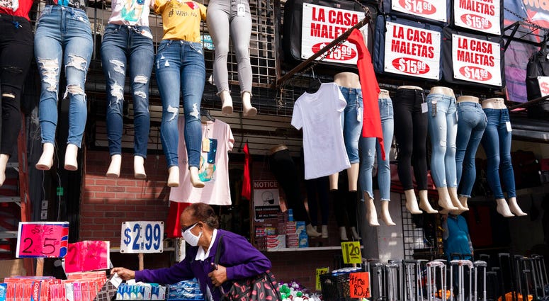 In this Sept. 25, 2020 file photo, a woman shops at a clothing store in New York. (AP Photo/Mark Lennihan, File) In this Sept. 25, 2020 file photo, a woman shops at a clothing store in New York. (AP Photo/Mark Lennihan, File)