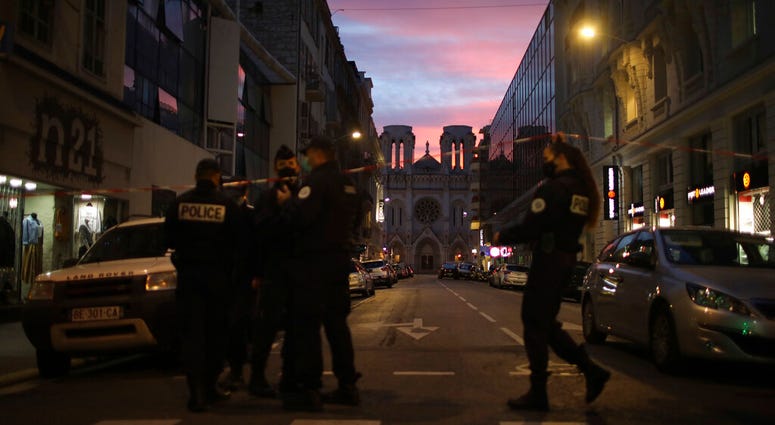 Police work behind a restricted zone near the Notre Dame church in Nice, southern France, after a knife attack took place on Thursday, Oct. 29, 2020. (AP Photo/Daniel Cole) Police work behind a restricted zone near the Notre Dame church in Nice, southern France, after a knife attack took place on Thursday, Oct. 29, 2020. (AP Photo/Daniel Cole)