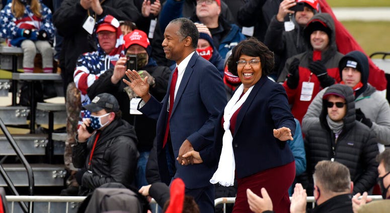 HUD Secretary Ben Carson, left, and his wife, Candy Carson, walk on stage at a campaign rally for President Donald Trump at Oakland County International Airport, Friday, Oct. 30, 2020, in Waterford Township, Mich. (AP Photo/Jose Juarez) HUD Secretary Ben Carson, left, and his wife, Candy Carson, walk on stage at a campaign rally for President Donald Trump at Oakland County International Airport, Friday, Oct. 30, 2020, in Waterford Township, Mich. (AP Photo/Jose Juarez)