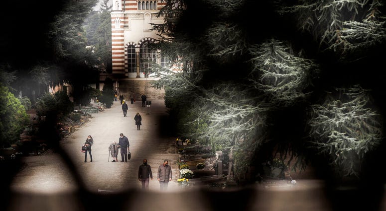 People walk in the Monumentale cemetery in the day devoted to remembrance of the departed, in Milan, Italy, Monday, Nov. 2, 2020. (AP Photo/Luca Bruno) People walk in the Monumentale cemetery in the day devoted to remembrance of the departed, in Milan, Italy, Monday, Nov. 2, 2020. (AP Photo/Luca Bruno)